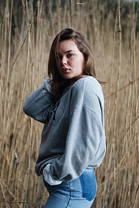 woman holding her hair near brown grass thumbnail