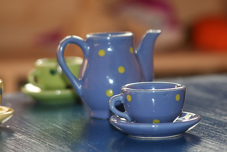macro shot photography of blue ceramic teapot and teacup thumbnail