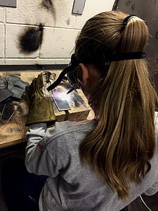 woman welding metal frame thumbnail