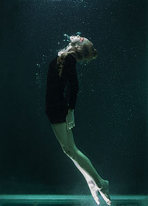 photo of woman underwater wearing black long-sleeve shirt thumbnail