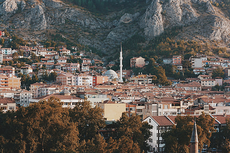 landscape photography of mountain surrounded by mid rise buildings thumbnail