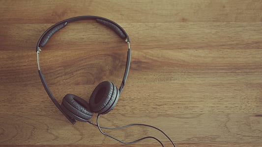black corded headphones on brown surface thumbnail