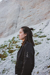 woman standing near rock during daytime thumbnail
