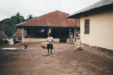 girl standing near houses thumbnail