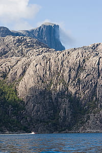 rock formation beside body of water thumbnail