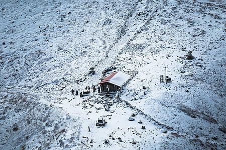 aerial photography of brown and white wooden house sorrounded by snow thumbnail