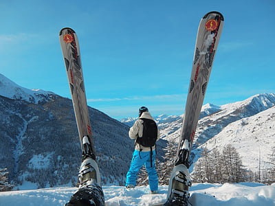 person standing on snow covered mountain at daytime thumbnail