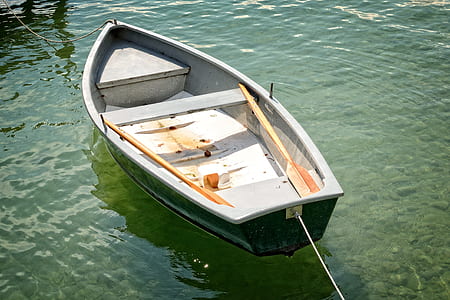 green canoe boat on body of water during day time thumbnail