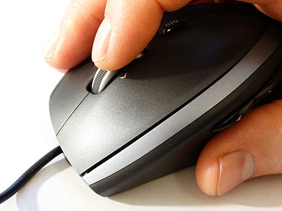 person holding corded gaming mouse thumbnail