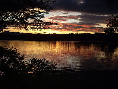 silhouette photo of body of water during sunset thumbnail