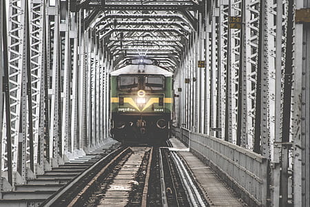 green and gray train near gray metal post at daytime thumbnail