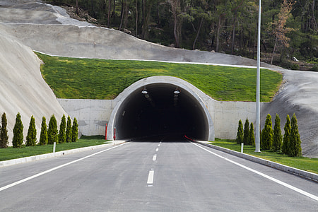 person taking photo of tunnel passage during daytime thumbnail
