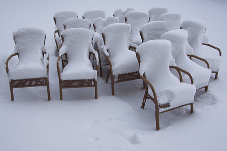 brown wooden armchairs covered by snow thumbnail
