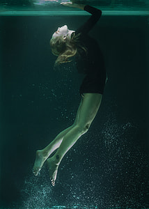 women in black longs-sleeve underwater photography thumbnail
