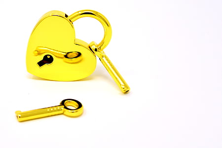 gold padlock with key on white surface thumbnail