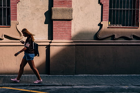 woman walking on sidewalk thumbnail