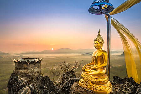 gold buddha figurine on mountain thumbnail