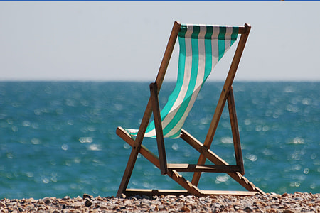 brown wooden sun chair on a stone during daytime thumbnail