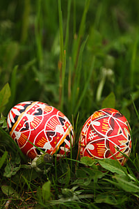 two red decorative eggs on green grasses thumbnail