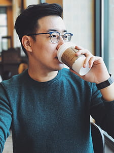 man sitting while drinking coffee thumbnail