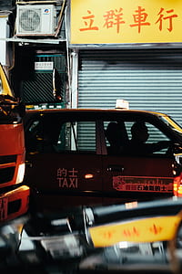 yellow Taxi parked in front of store thumbnail