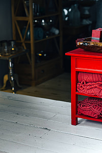 Folded sweaters and fabrics stacked on shelves thumbnail