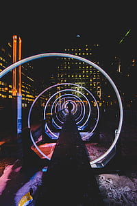 person standing in purple pathway during night time thumbnail
