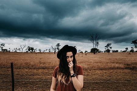 woman standing near fence thumbnail