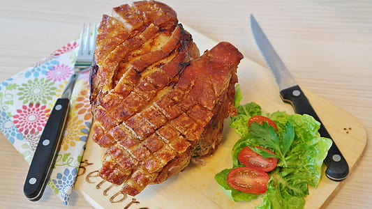 meat dish with vegetables on brown chopping board thumbnail