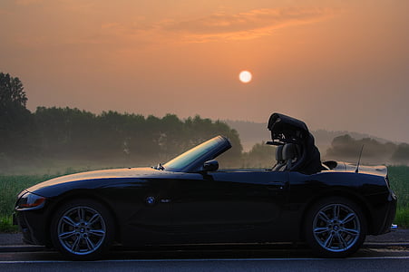 black convertible coupe parked on road thumbnail