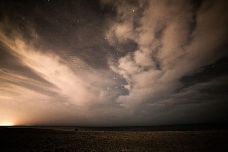 grey sand under blue and white sky thumbnail