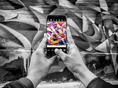 person holding smartphone taking picture the wall thumbnail