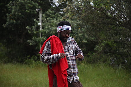 man carrying red blanket thumbnail