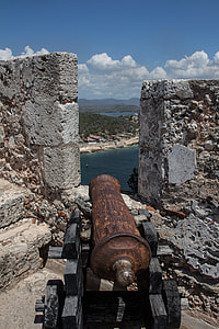 brown and black mortar canon beside concrete wall thumbnail