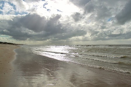 white sand beach under white clouds thumbnail