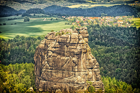 brown rock formation surrounded by trees in forest during daytime thumbnail