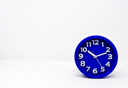 round blue analog wall clock reading 10:11 thumbnail