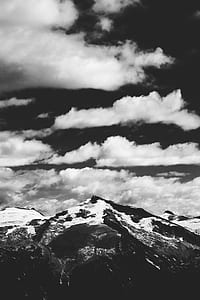 snow covered mountain under cloudy sky thumbnail