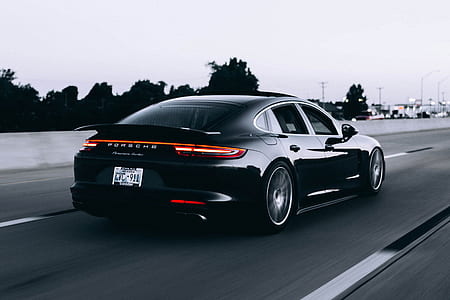 grayscale photo of Porsche sedan on gray road thumbnail