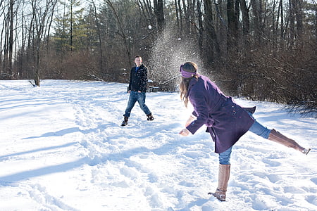 man and woman playing outside during winter thumbnail