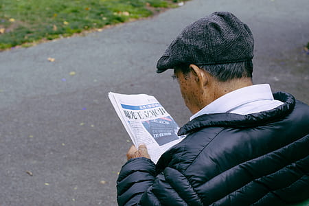 man reading newspaper thumbnail