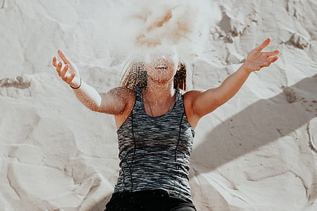 woman wearing black space-dyed tank top throwing sand thumbnail