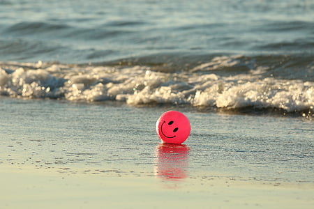 red smiley emoji ball on seashore thumbnail