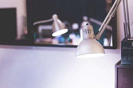 turned on gray study lamp near mirror thumbnail