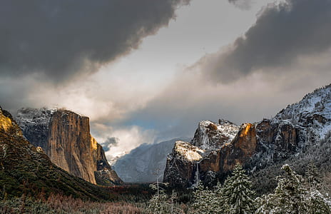 brown mountain covered by snow under gray skies thumbnail
