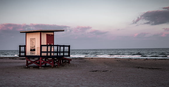 beige shed in front of beach thumbnail