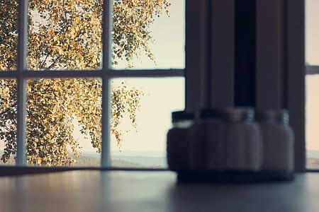 four condiment shaker on table near the window thumbnail