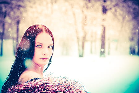 selective focus photography of woman wearing faux fur coat thumbnail