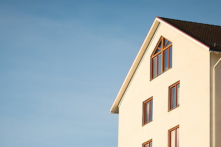 white painted house under blue sky thumbnail