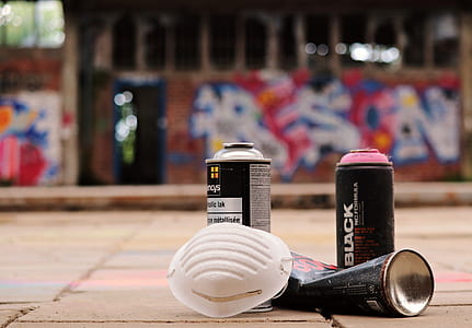 selective focus photography of black spray can and white mask thumbnail
